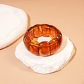 Macro shot of amber acrylic elastic bracelet featuring multi-layered rectangular beads - Dark Coffee