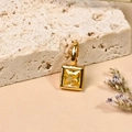 Square 18K gold plated birthstone pendant with yellow zircon on a textured stone base - November/Yellow
