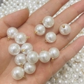 Macro shot of high-luster white faux pearl charms with gold metal caps for jewelry making - 8mm Pearl Eye Pin Pendant / Pure White Pearl KC Gold Eye Pin