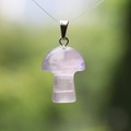 Natural purple crystal mushroom pendant with metal clasp on a green background - Fluorite