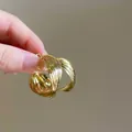 Macro view of multi-layered gold circle hoop earrings held to show scale and texture - 1# Silver Earring Post - Braided Hoop