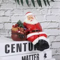 Resin Santa Claus figurine sitting with gift bag of trees and teddy bear ornament - Santa With Right Bag