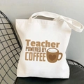 White canvas tote bag for teachers featuring Teacher Powered by Coffee print design - Teacher Powered by Coffee