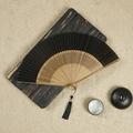 Classic Chinese silk folding fan in elegant black with bamboo ribs and tassel - Black / 23CM