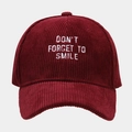 Close-up of wine red corduroy baseball cap with white Don't Forget To Smile embroidery - Adjustable / Burgundy
