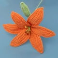 Detailed close-up showing the knit texture and craftsmanship of a handmade orange yarn lily - Finished Lily Stems - Orange