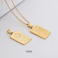 Macro view of gold Libra zodiac pendant with etched goddess and stars on steel plate - Libra