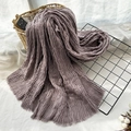 Purple cotton scarf with crinkle texture and fringe edges displayed on a table - Taro Purple
