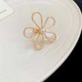 Detailed top view of a gold flower ring with pearl inlay on a ceramic tray - Hollow Flower Ring / Gold Pearl Flower Style (5#)