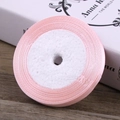 Light pink satin ribbon roll for gift wrapping and hair accessories on a wooden background - Light Pink