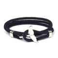 Detail of blue braided Milan rope bracelet featuring a polished silver whale tail anchor - Silver Whale Tail Buckle / Navy Blue