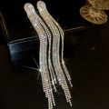 Macro shot of silver tassel earrings with sparkling cubic zirconia and shimmering starlight effect - 15-Silver Pin-Gold-Step Tassel