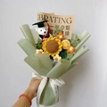 Handcrafted knitted sunflower bouquet featuring graduation bear in light green paper wrap - Splendid Future