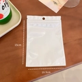 Translucent white PVC zipper storage bag for jewelry, size 10.5cm x 15cm on wood desk - 10.5cm x 15cm / White