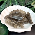 Natural smoky quartz crystal point stones in a decorative shell tray with green leaves - Smoky Quartz