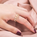 Close-up of elegant gold marquise zircon leaf ring on model with silk background - Gold Marquise Leaf