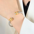 Twisted cable cuff bracelet in silver and gold finish with light blue center stone - Z059-Blue Zirconia Single Layer