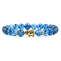 Detail of blue cracked crystal beaded bracelet with a gold elephant charm and spacers - Blue Crackle Crystal
