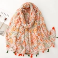 Artistic summer scarf featuring orange floral prints and colorful tassels on white background - Orange Floral with Emerald Fringe (SL2408-005)