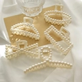 Five styles of elegant pearl hair clips set on white silk for a vintage aesthetic look - Pearl Style - Random Design