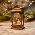 Bronze vintage Christmas lantern with snowman and pine tree scene on a snowy wooden table - Flat Lamp Snowman Style (No Water)