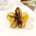 Close-up of amber translucent resin flower hair claw clip with 5-petal design and glossy finish - Gradient Coffee Yellow