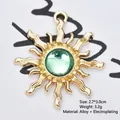 Detailed view of a 2.7x3.0cm golden sun-shaped alloy pendant with a green gemstone inlay - Transparent Green