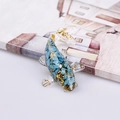 Fish figurine ornament featuring blue crushed crystals and gold leaf accents - Turquoise