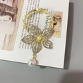 Golden hair claw with rhinestone flower, pearl center, and elegant teardrop pearl pendant - F0456 Gold Hollow Flower