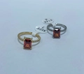 Detailed view of square red gemstone rings in gold and silver with diamond accents - US 7 / Garnet Red