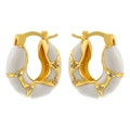 Detailed macro view of gold-plated hollow enamel hoops with clear cubic zirconia stones - White