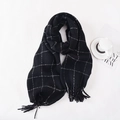 Winter plaid scarf in black and white check pattern with fringe tassels on white background - Black