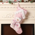 Detail of pink knitted Christmas stocking with a sequined snowman doll on a mantel - Pink Snowman Christmas Stocking