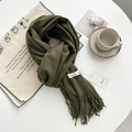 Army green cashmere-feel scarf with tassels and brand tag on a white table set - Army Green