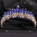 Detailed macro shot of golden alloy bridal crown featuring blue marquise crystals and rhinestones - Gold White & Blue Rhinestone