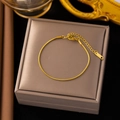 Detailed close-up of a gold snake chain bracelet with adjustable lobster clasp and extender - Gold Snake Chain Bracelet (SLE136)