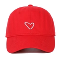 Detailed view of red cotton baseball cap featuring white heart embroidery on the front - Red