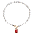 Elegant pearl necklace with red ruby pendant and decorative golden OT clasp closure - Gold with Red Stone