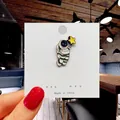 Cute enamel pin badge featuring a white astronaut holding a bright yellow star - 54*Astronaut Holding Star Pin