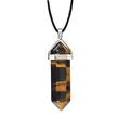 Macro detail of hexagonal tiger eye crystal pendant with silver clasp and black cord necklace - Tiger Eye with Cord