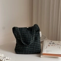 Detailed view of dark green plaid tweed tote bag with a minimalist woven brand label - Dark Green Small Plaid