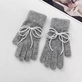 Detail view of grey knit gloves featuring decorative white pearl bow accents - M / Light Grey (Gloves)