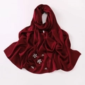 Detail of burgundy satin silk hijab featuring handcrafted rhinestone floral patterns - Burgundy