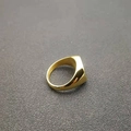 Detailed top view of a wide polished gold-plated stainless steel band ring with mirror finish - US 6 / Gold