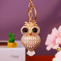 Close-up of golden owl keychain with sparkling rhinestones and black gem eyes - Heart Owl White