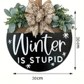 Round wooden door hanger featuring Winter IS STUPID text with eucalyptus and burlap bow - Winter Black Sign