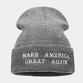 Close-up detail of white embroidered text on a gray knit beanie with ribbed texture - Dark Gray