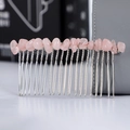Macro shot of pink crystal stones hand-wrapped on a silver metal hair comb detail - Rose Quartz + 20-Tooth Silver Comb