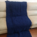 Handmade chunky knit chenille blanket in deep blue draped over a leather sofa - 25*100cm / Dark Blue