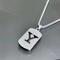 Macro shot of silver letter Y pendant in rectangular military tag style with steel chain - Letter Y
